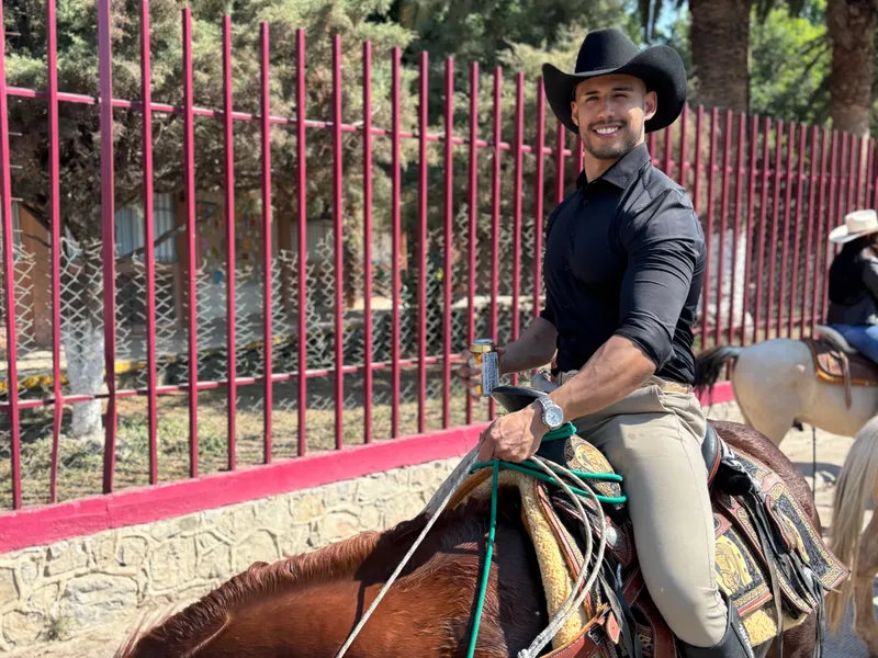 Bruno on horseback wearing a cowboy hat in Mexico
